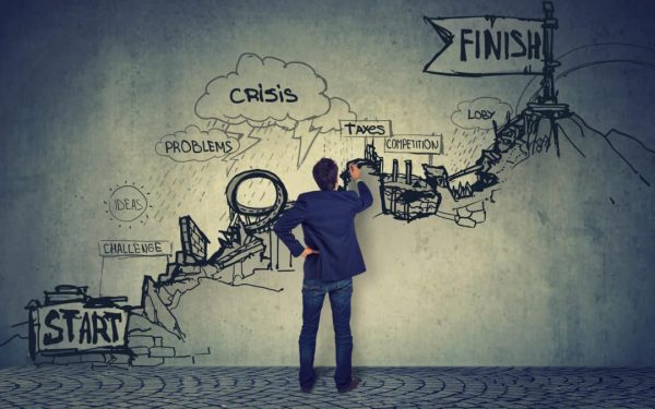 Business career challenges concept. Businessman looking at a sketch of troubles on the way up