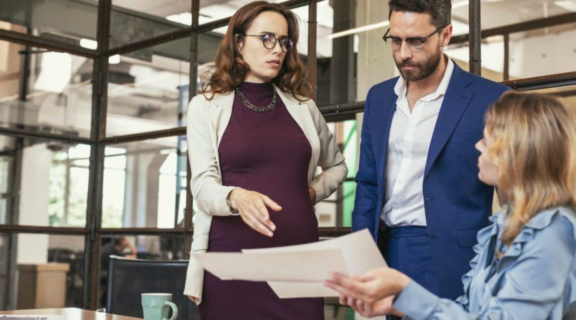 Business perspective. Concerned three colleagues having meeting and examining document