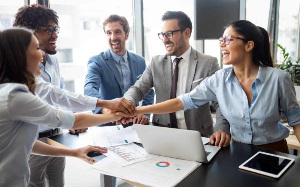 Happy smart business people celebrating success at company.