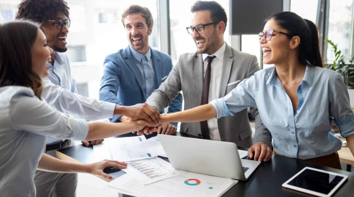 Happy smart business people celebrating success at company.