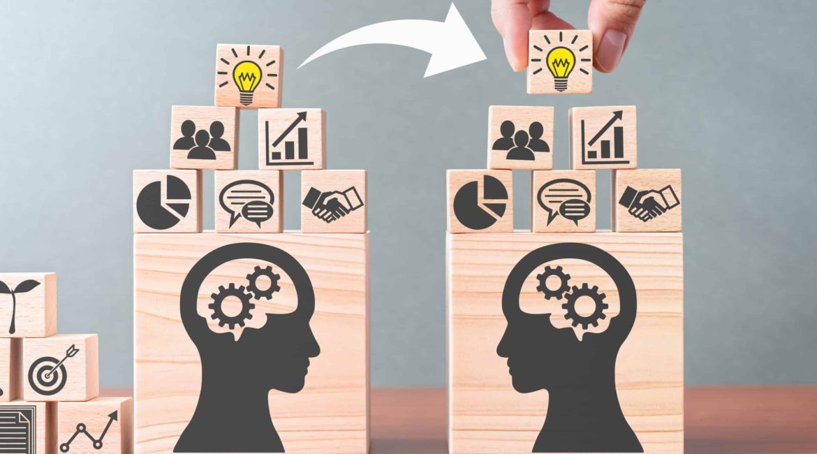 Knowledge transfer. Business knowledge management. Building wood blocks on table.