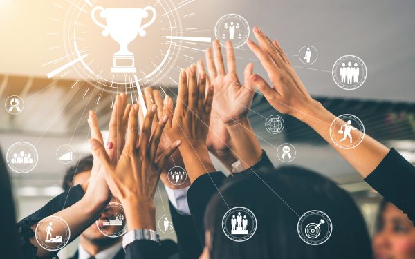 Achievement and Business Goal Success Concept - Creative business people with icon graphic interface showing employee reward giving for business success achievement.