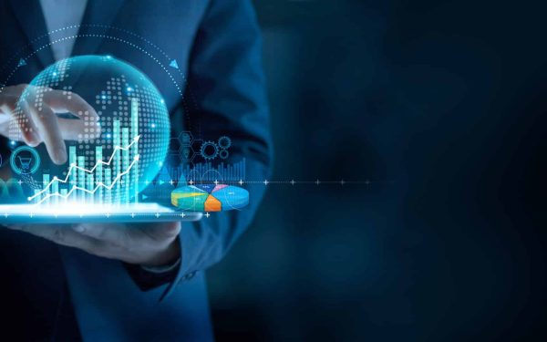 Businessman using tablet analyzing sales data and economic graph chart to resume business growth in the economic crisis, Rethink, Reinvent and Recover.