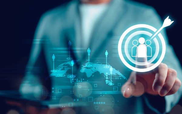 Businessman touching virtual human icon on dartboard with arrow for Global business CRM or Customer Relation Management and customer focus target group concept, social media. Digital marketing online.